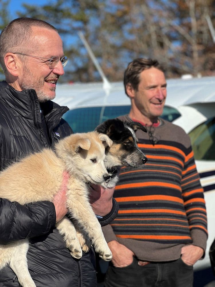 ARF's Scott Howe with puppies in hand with Dr. Dempsey.
